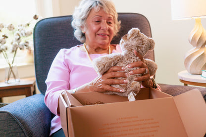 Smiling grandma cuddling her Teddy Prayer Prayer Bear